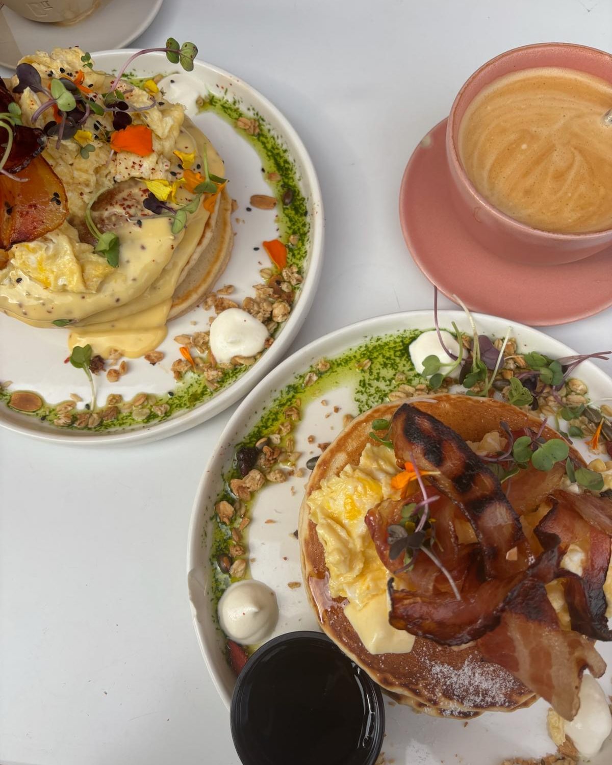 Twee borden pancakes met spek en ei en een cappuccino bij Brunch It in Málaga